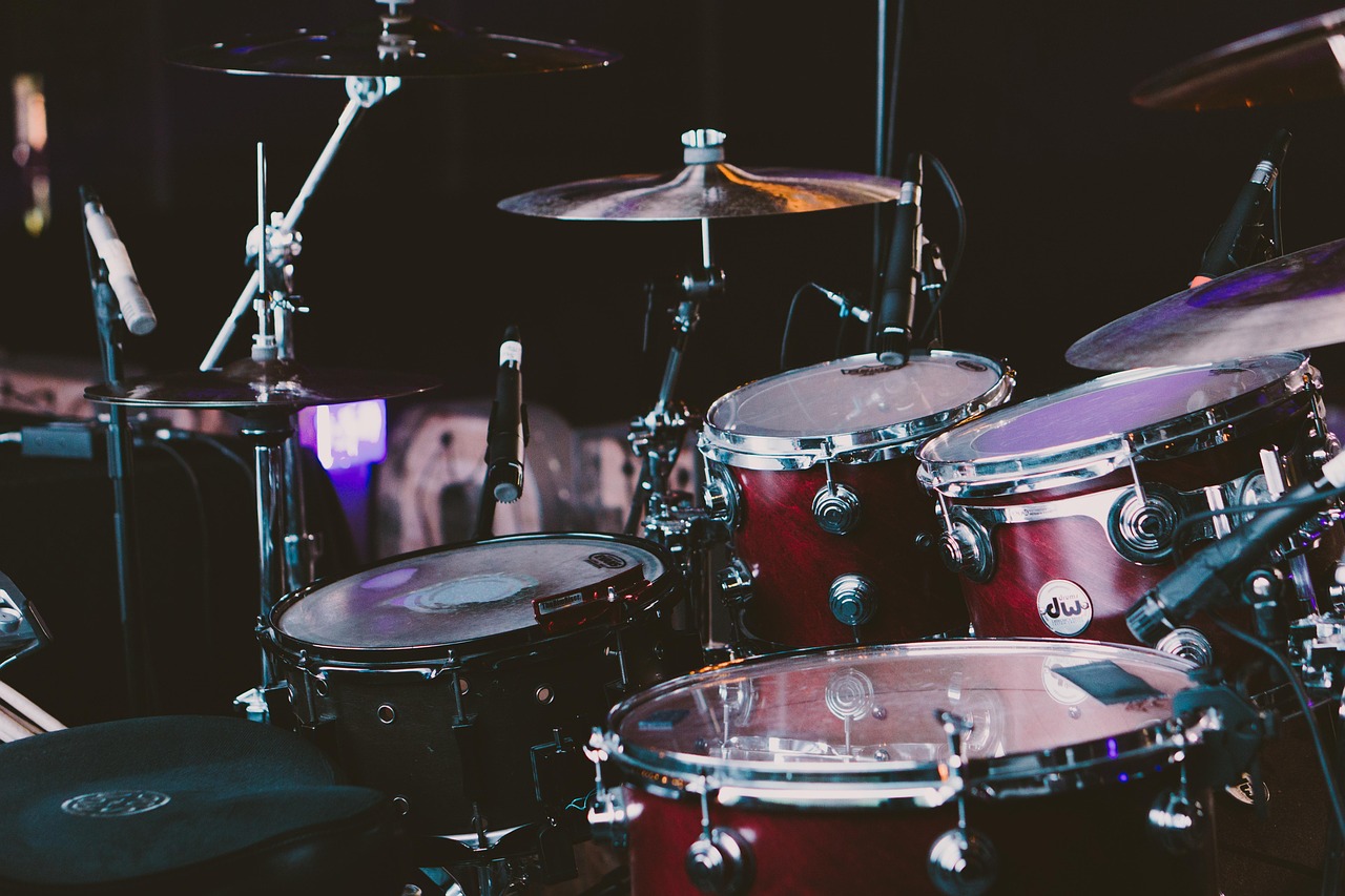Close view of a drum kit and cymbals under warm stage light